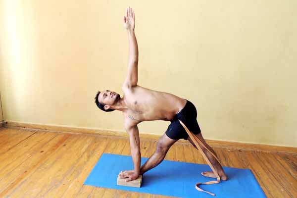 Parivrtta  trikonasana using strap