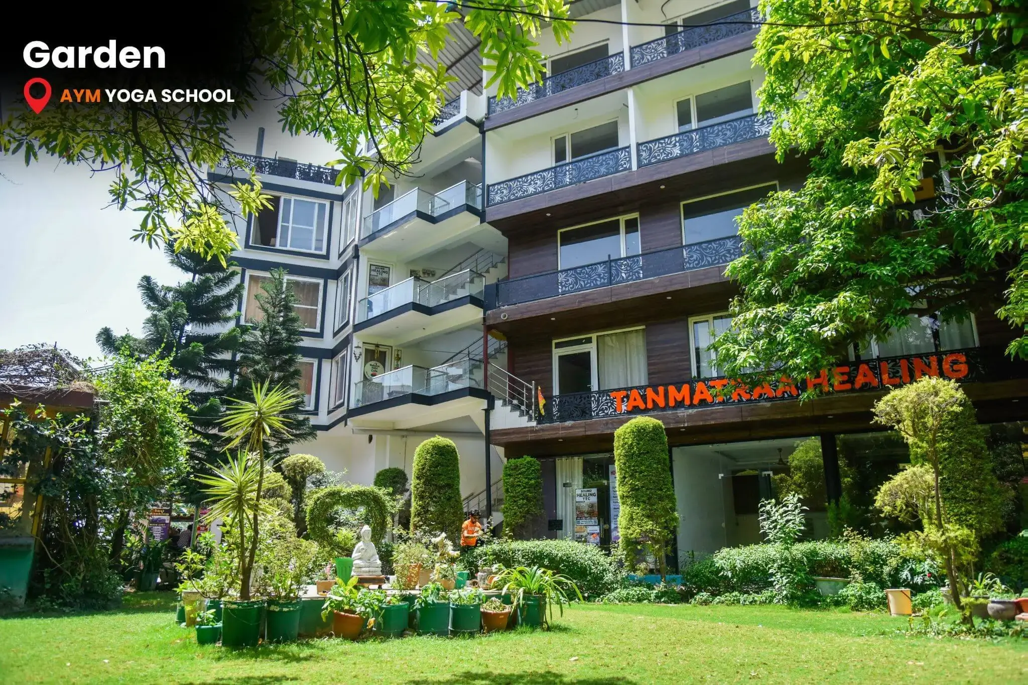 Lush green garden inside AYM Yoga School Rishikesh campus