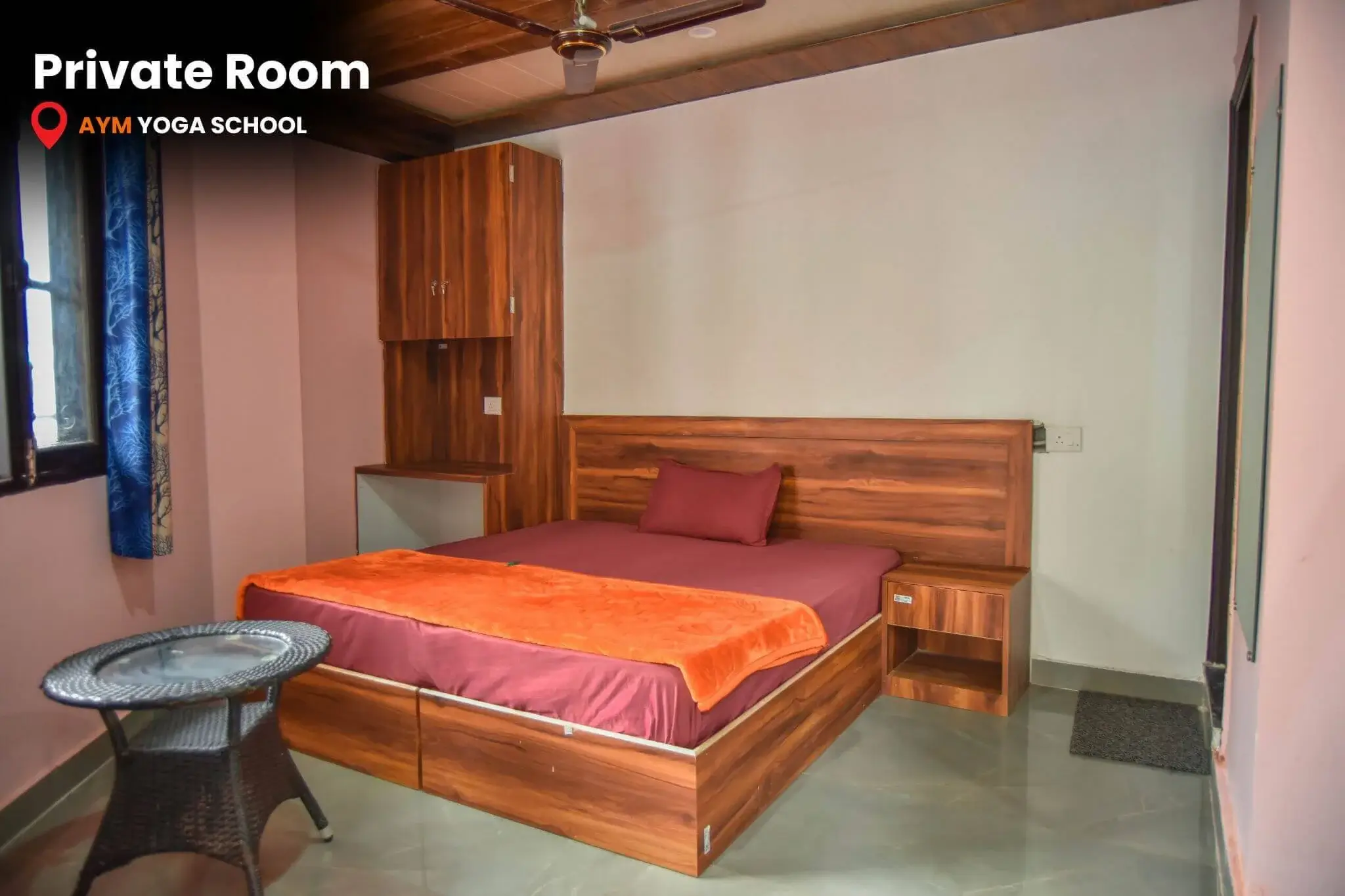 Comfortable private room with double bed and personal workspace at AYM Yoga School