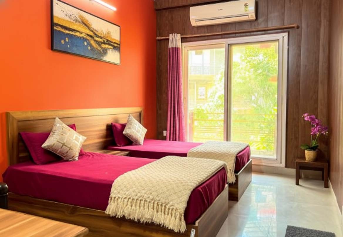 Twin shared room with two single beds and shared storage space at AYM Yoga School